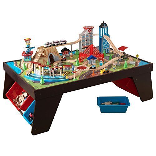 Table Train Set / Hape Railway Play And Stow Wooden Train Set Activity Toy Storage Play Table Target / A crane lifts and lowers cargo onto the train and a helicopter soars over the town with blades spinning.