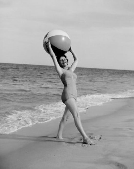 Posterazzi SAL255424611 Young Happy Woman Holding Beach Ball & Looking at Camera at Beach Poster Print - 18 x 24 in.